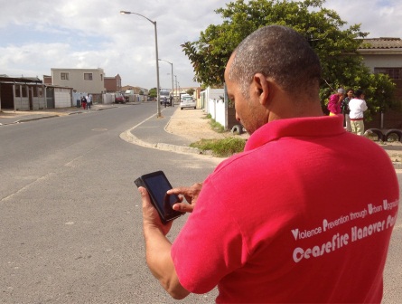 A member of the CeaseFire team using Safety Lab’s Commcare app on the streets of Hanover Park, Cape Town - Photo from dimagi.com